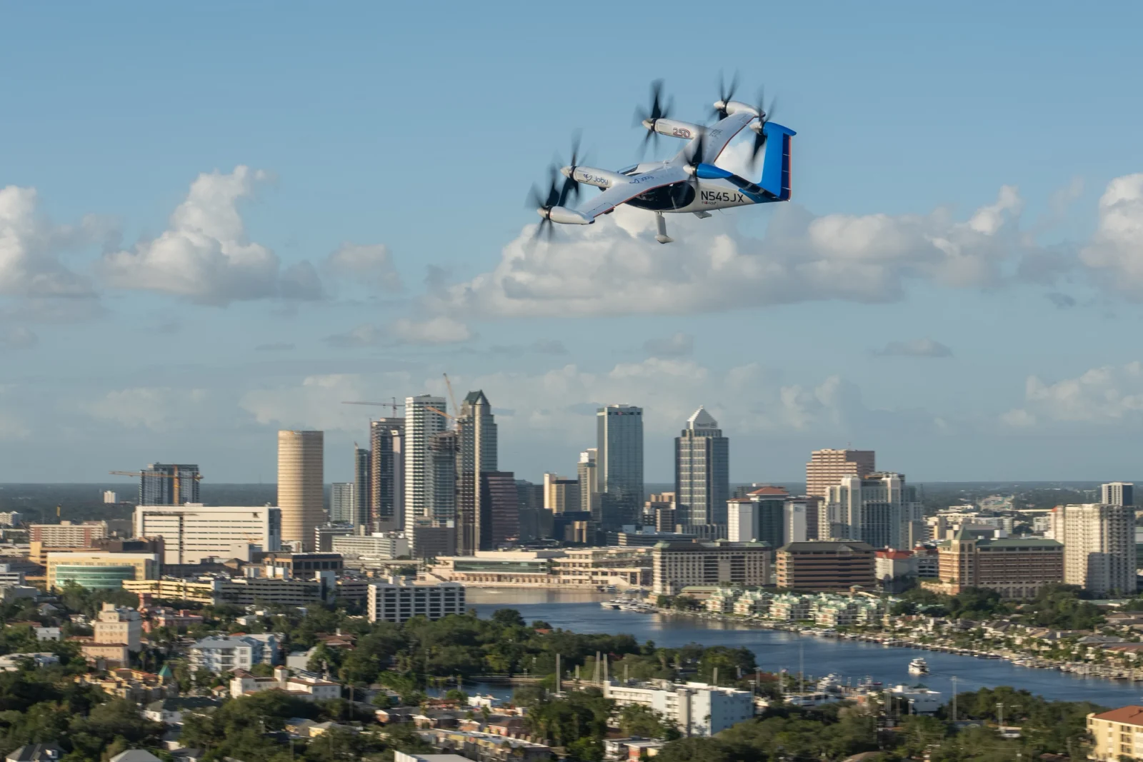 Joby electric air taxi flying above Tampa’s skyline